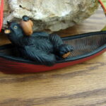 Willie Black Bear Relaxing in a Red Canoe Ornament