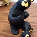 Retired Big Sky Carvers Bearfoots Bears Jeff Fleming Standing w/ Cub Holding Flag?